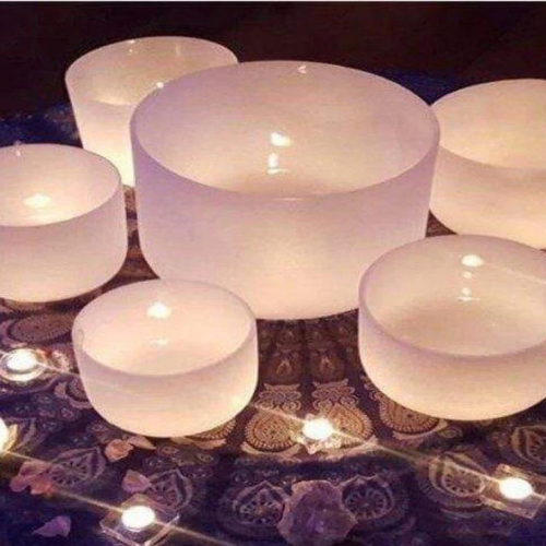 White crystal bowls with water and tealights floating in them.